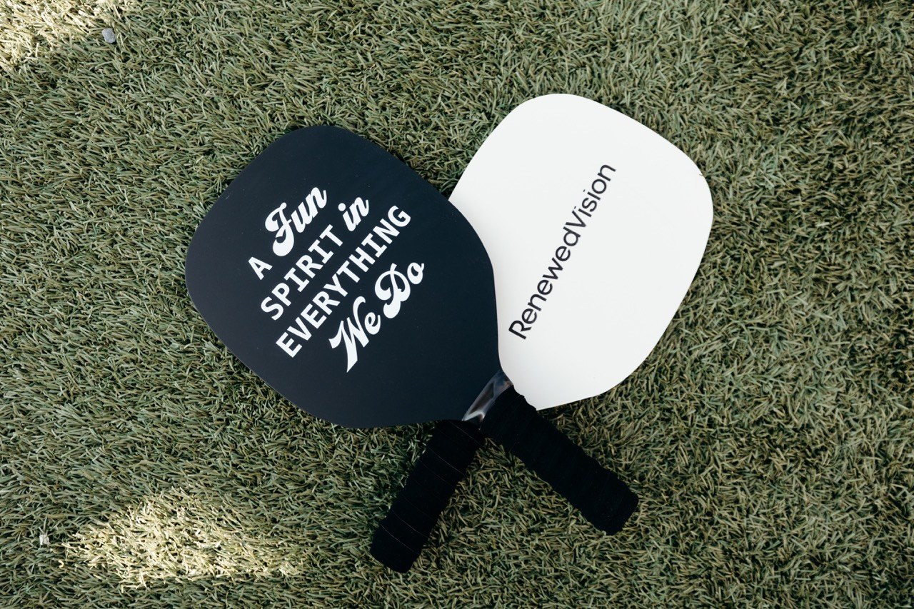 Branded pickleball paddles on turf