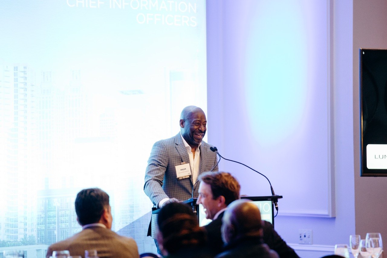 Speaker at a podium in a bright ballroom