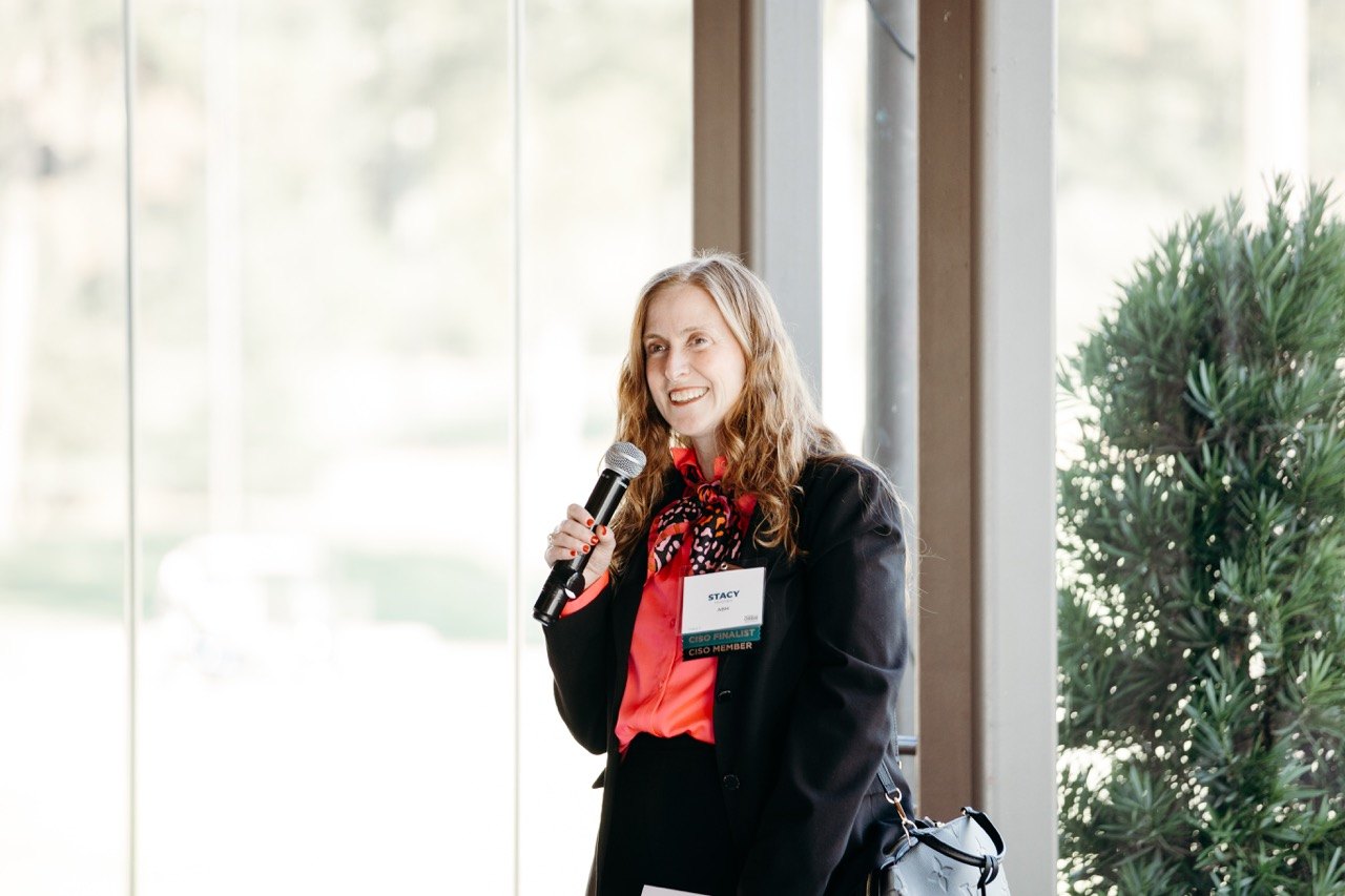 Presenter beside tall windows
