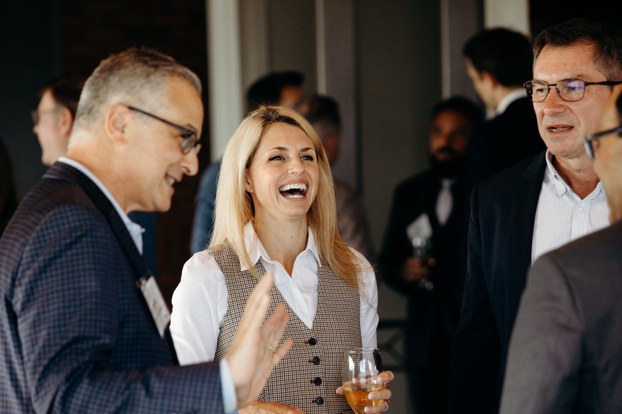Guests laughing together at a reception