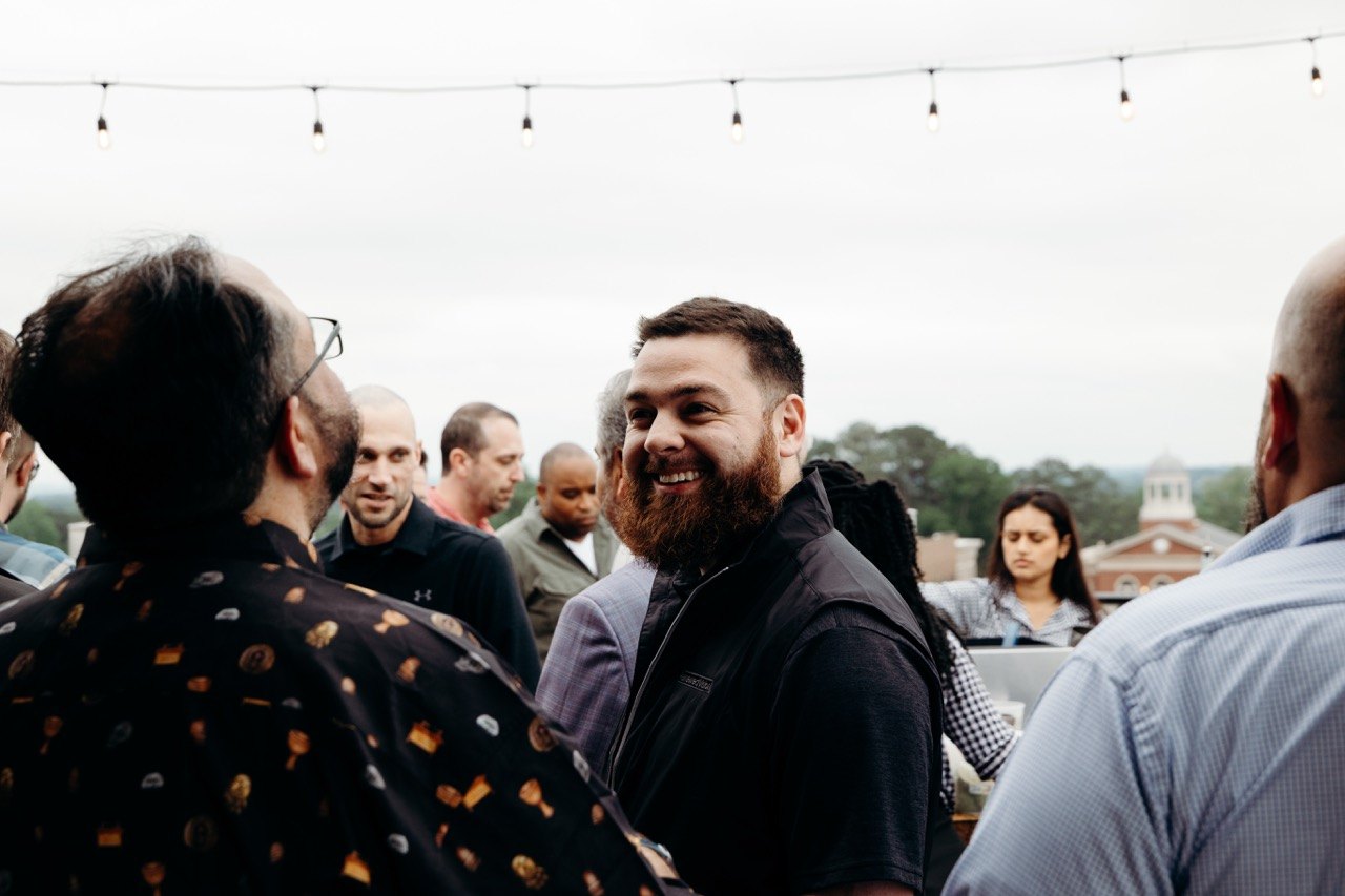 Guests laughing at a rooftop gathering