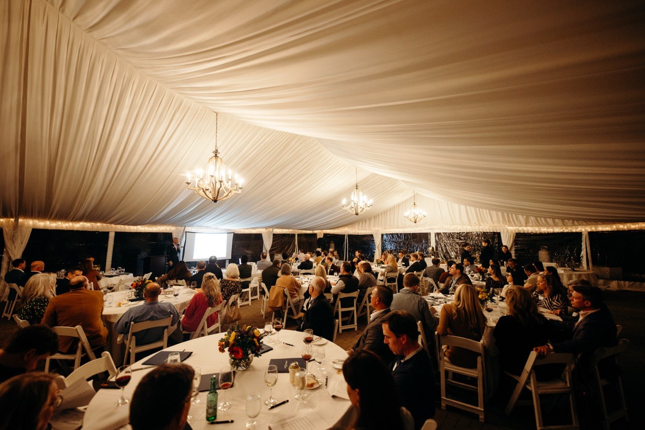 Seated dinner under a draped tent