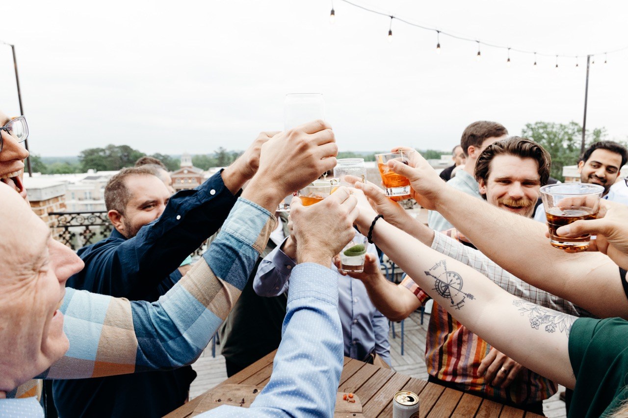 Colleagues raising a toast on a rooftop