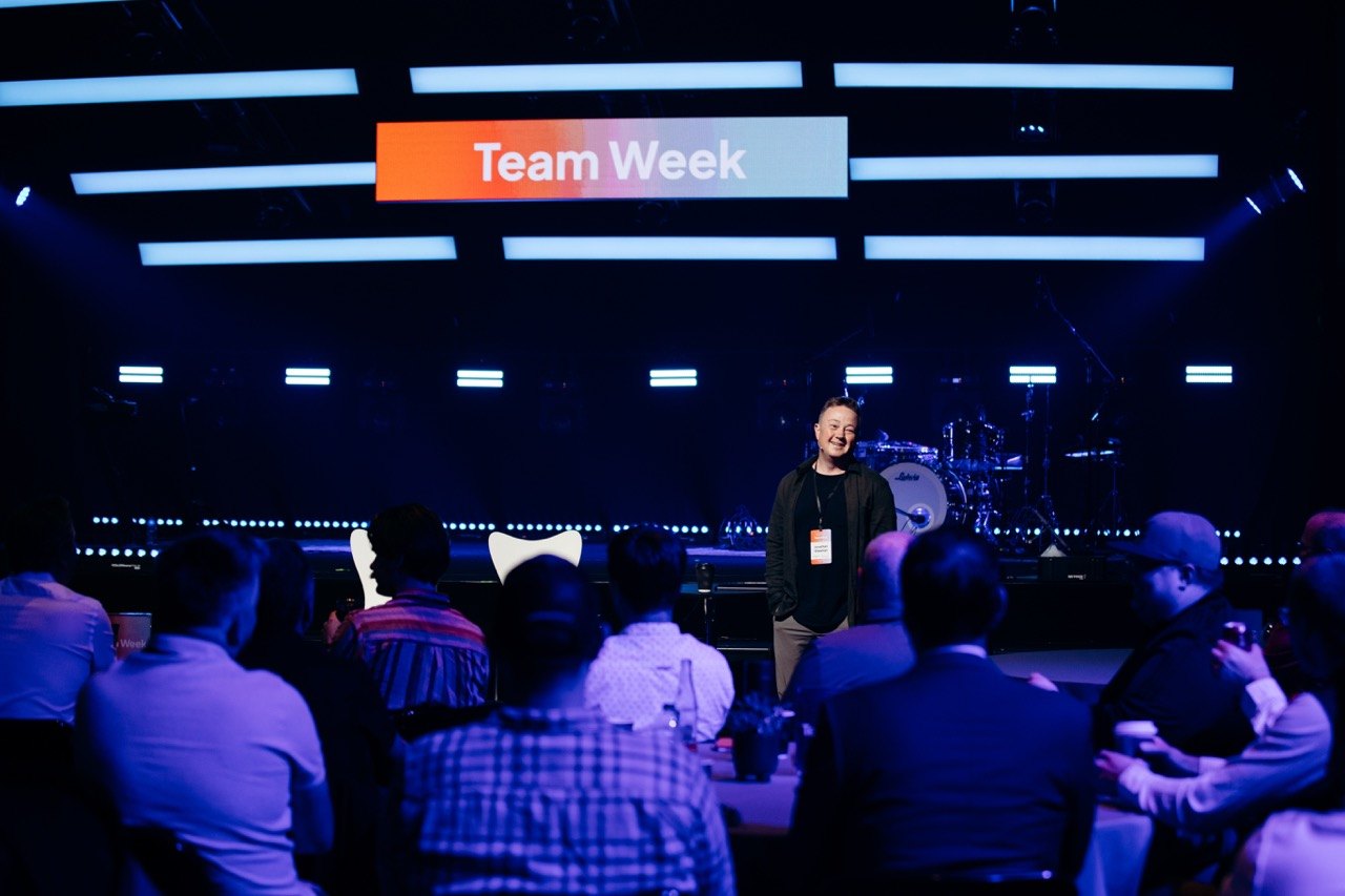 Wide view of a keynote stage with the audience seated